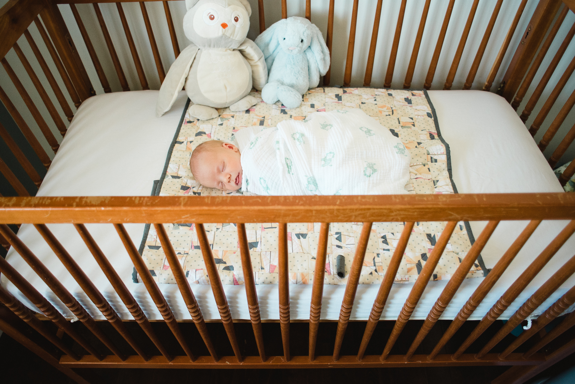 newborn baby boy sleeps in his crib