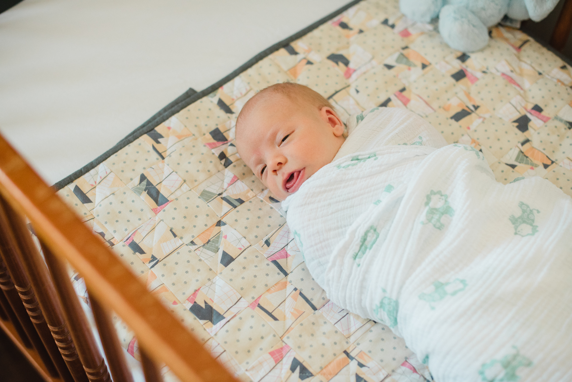 newborn baby boy sleeps in his crib
