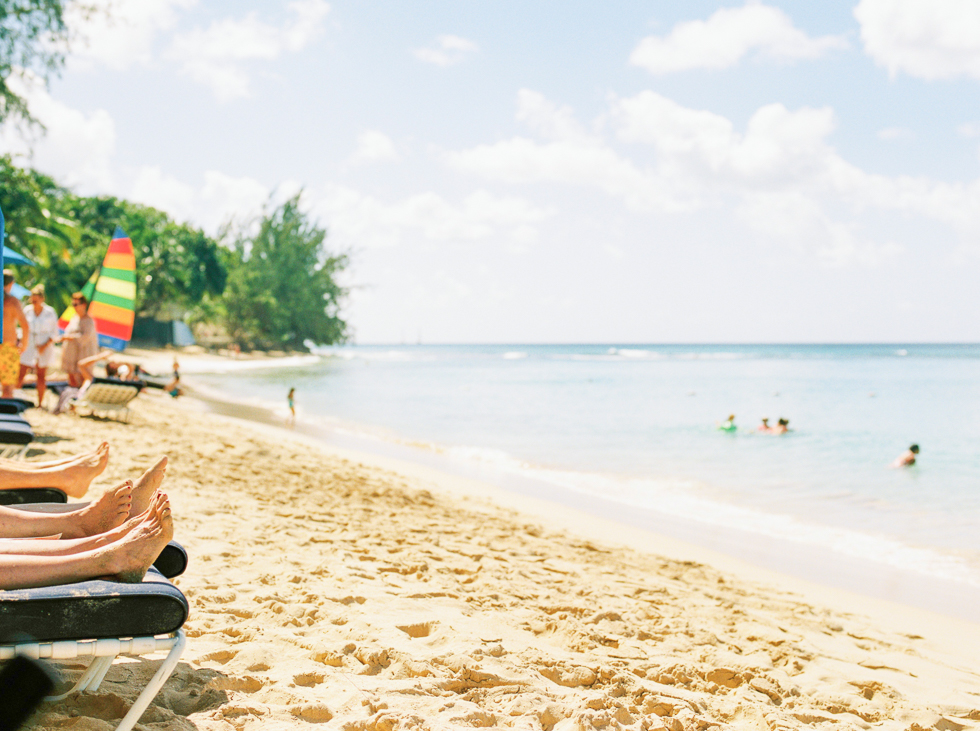 Beach goers with sandy feet on Mullins Beach, Barbados