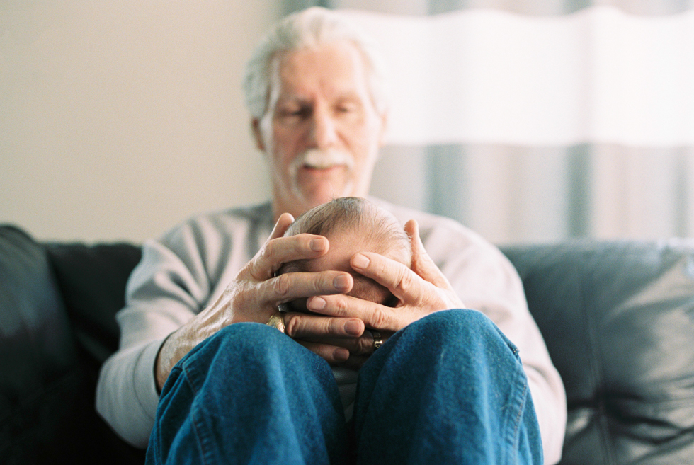 grandfather snuggles his grandson