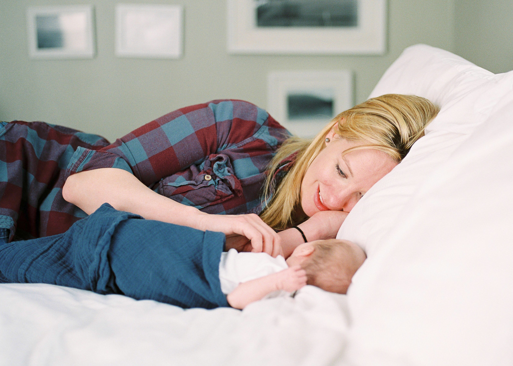 mom-newborn-baby-lying-bed